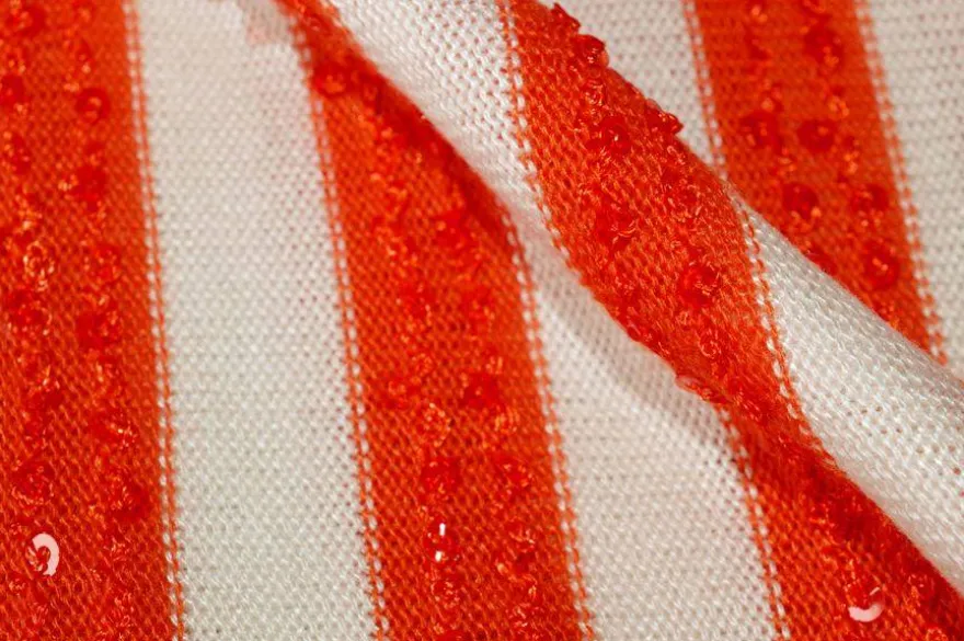 TESSUTO MAGLINA RIGATO CON PAILLETTES APPLICATE ARANCIO