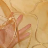 TESSUTO TENDA ORGANZA ORO CON RICAMO IN RILIEVO